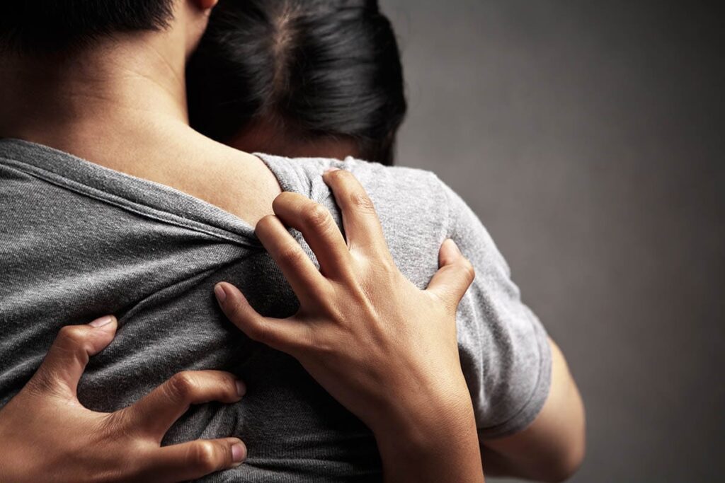two people embracing as they work through codependency in recovery