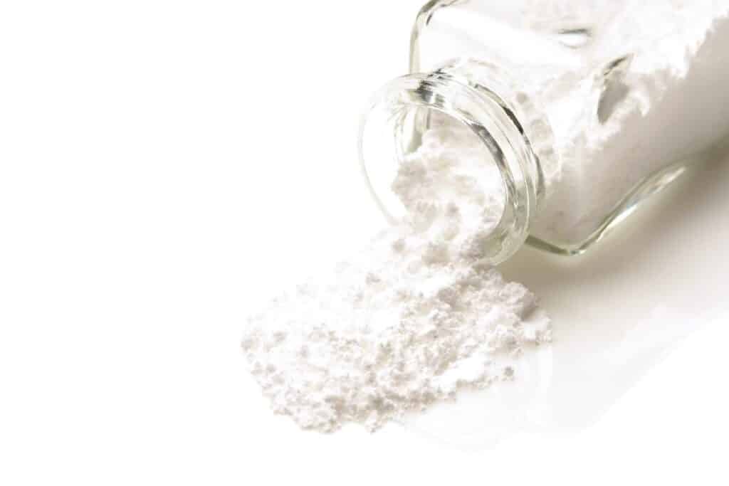 an image of cocaine spilling from a jar as a white powdery substance