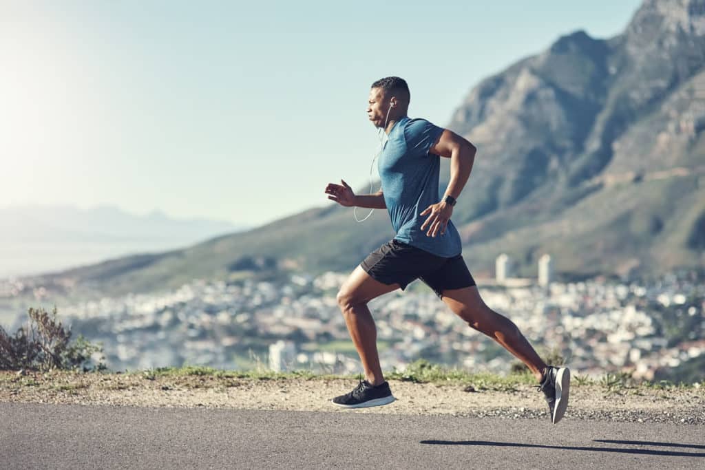 male running with headphones who looks like a pro athlete in recovery