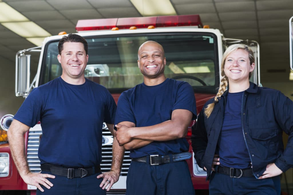 two males and female firefighters are smiling because Swift River Now Offering Specialized Programming For First Responders