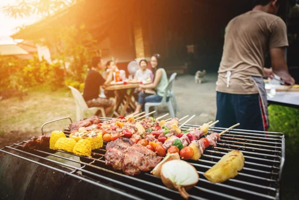 a man grills all kinds of tasty food at a sober summer celebration barbecue
