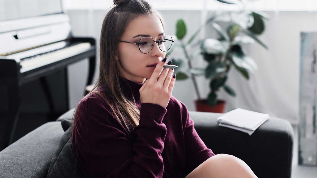 girl sitting and smoking marijuana