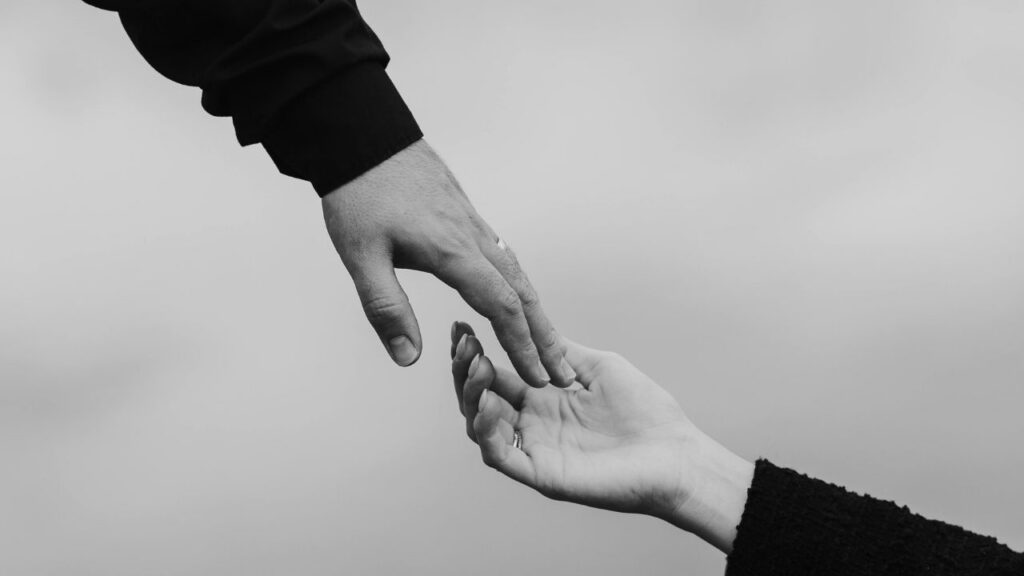 Friend reaching out to help someone fighting heroin addiction