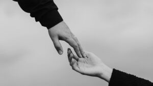 Friend reaching out to help someone fighting heroin addiction